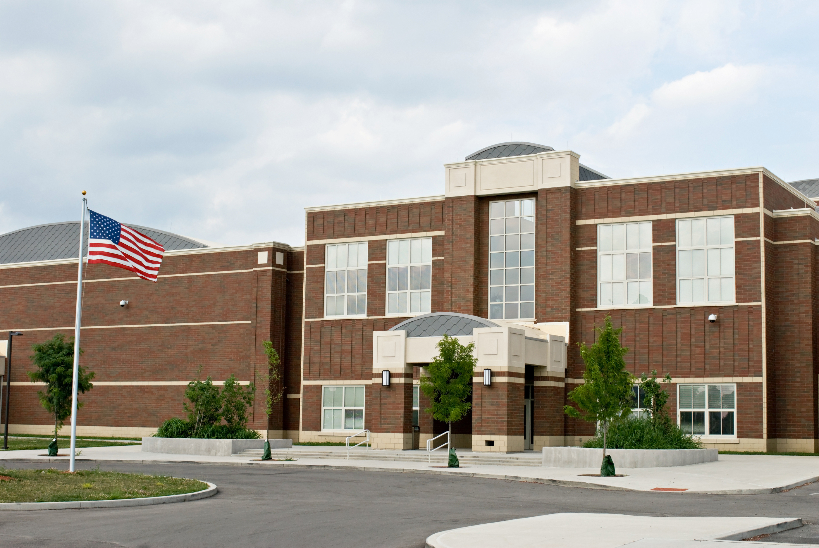 bigstock-School-Building-with-Flag-20186147.jpg